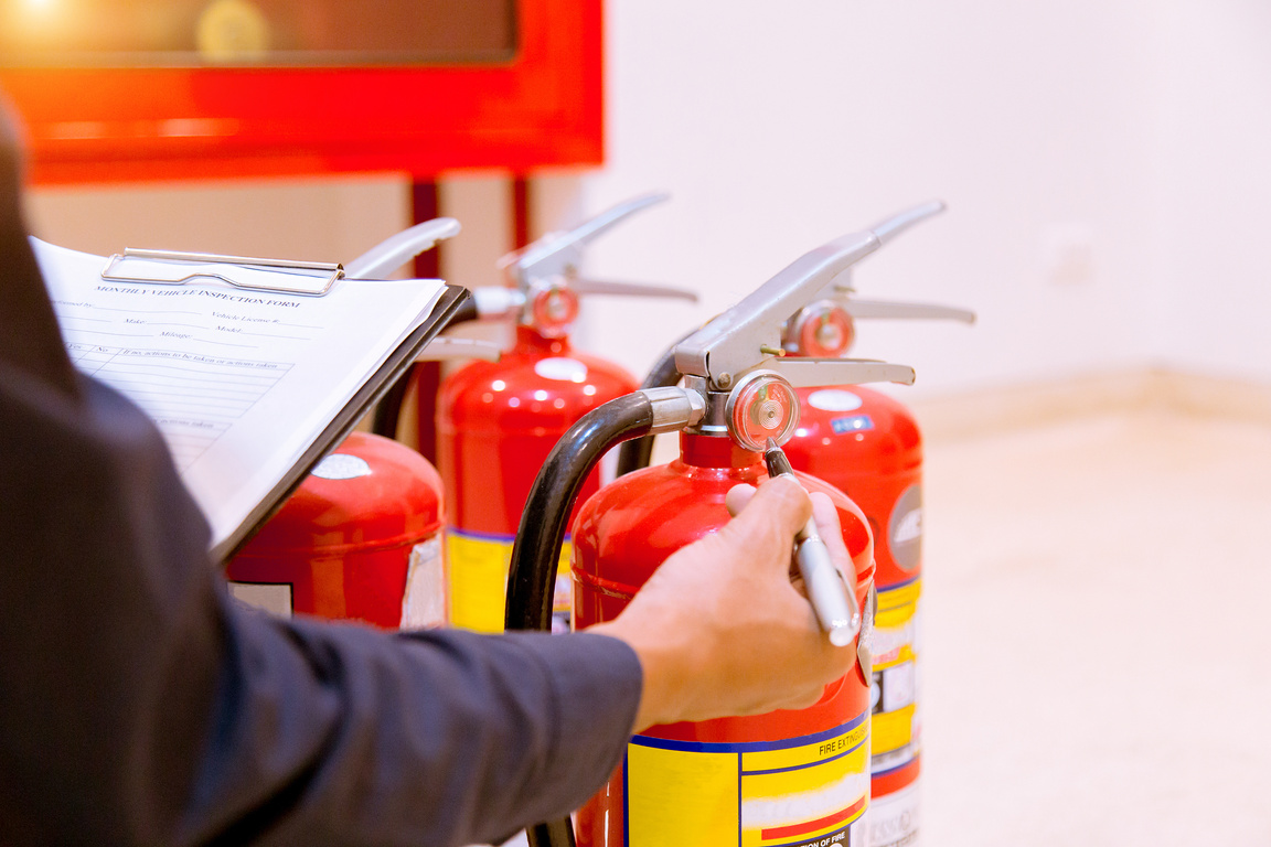 Male Professional inspection Fire extinguisher,safety concept.